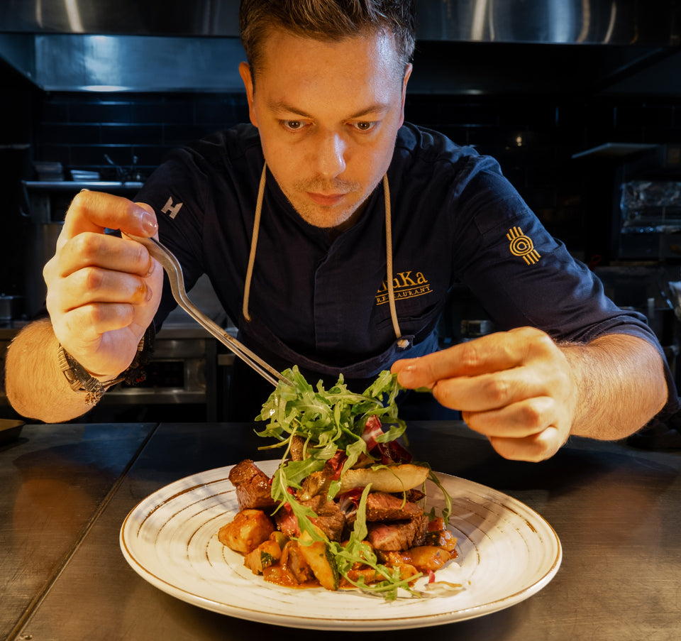 Chef Max finishing a plate by hand in the kitchen at Restaurant Iluka, Jeonju